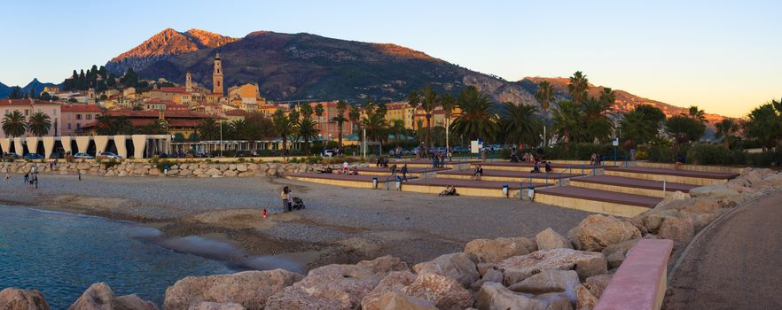 Beautiful Sunset on the beach and the town of Menton, French Riviera
