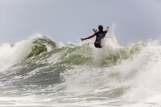 SNAPPER ROCKS, GOLD COAST, AUSTRALIA - 9 MARCH: Unidentified Surfer races the Quicksilver & Roxy Pro World Title Event. 9 March 2013, Snapper Rocks, Gold Coast, Australia