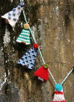 Handmade ornament for winter holiday, group fo knitted pine tree to decor for christmas season, colorful knitting product with button to Xmas decoration
