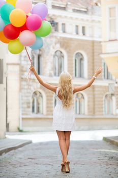 summer holidays, celebration and lifestyle concept - beautiful woman with colorful balloons in the city