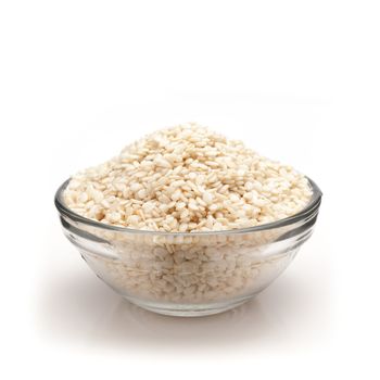 Front view of Organic White Sesame (Sesamum indicum) in glass bowl isolated on white background.