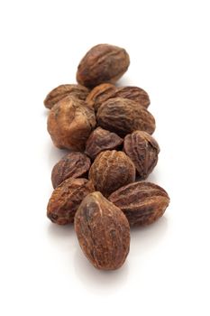 Row of Organic Inknut or Harr (Terminalia chebula) isolated on white background.