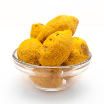 Front view of Organic Round Turmeric or Haldi (Curcuma longa) in glass bowl isolated on white background.