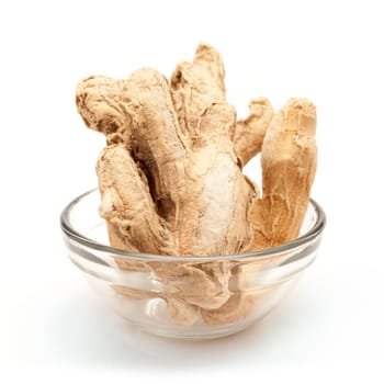 Front view of Organic Dried Ginger root or Sonth (Zingiber officinale) in glass bowl isolated on white background.
