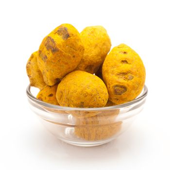 Front view of Organic Round Turmeric or Haldi (Curcuma longa) in glass bowl isolated on white background.
