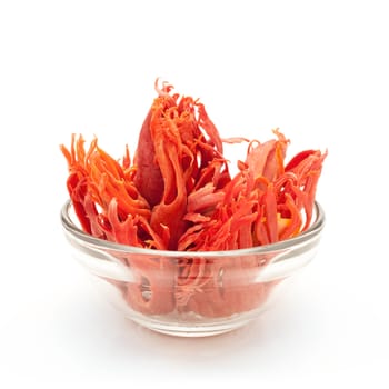 Front view of Organic Mace or jayitri (Myristica fragrans) in glass bowl isolated on white background.