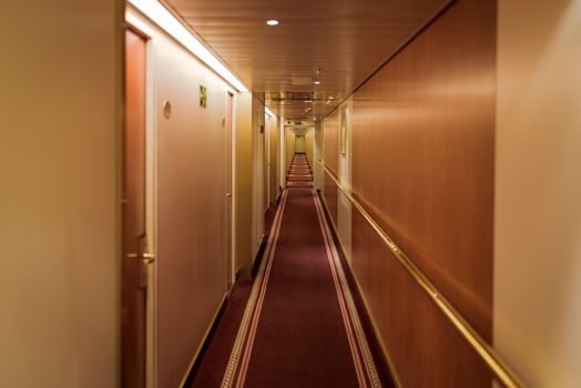 Narrow corridor with cabins at cruise ferry