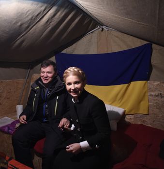 UKRAINE, Kiev: Leader of the parliamentary faction of the Radical Party Oleg Lyashko (L) and leader of the parliamentary faction of the party Batkivshchyna Yulia Tymoshenko (R) talk together after attending a political rally against the current government, in front of the Cabinet of Ministers, in Kiev, on November 1, 2015. 