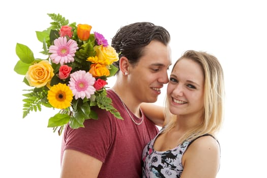 Girl is happy with bouquet of flowers giving by boyfriend over white background