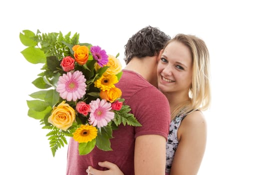 Girl is happy with bouquet of flowers giving by boyfriend over white background