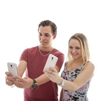 Young couple making selfie with two phones over white background