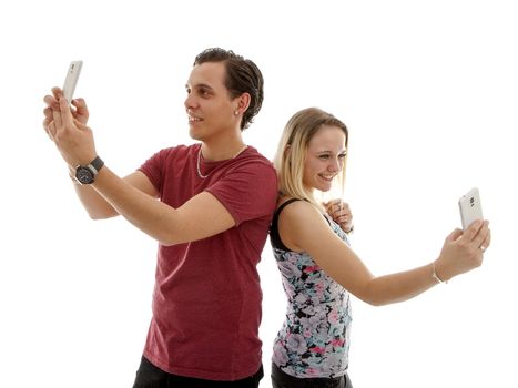 Young couple making selfie of themselves over white background