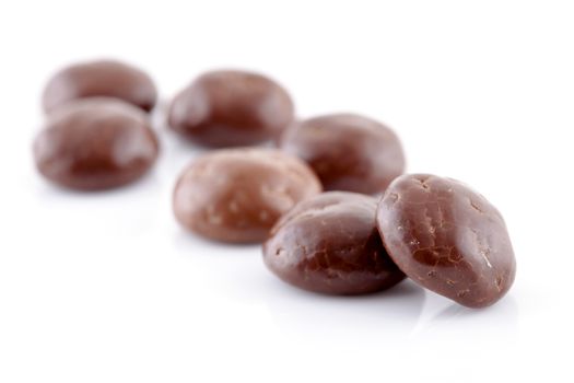 Typical dutch sweets: chocolate pepernoten (ginger nuts) for a celebration at 5 december in the Netherlands over white background