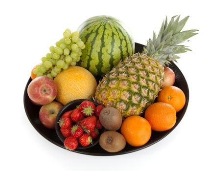 Big plate with lots of healthy fruits over white background