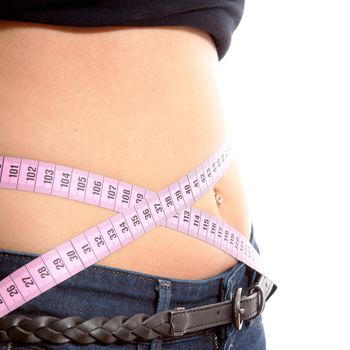 diet, young woman is measuring her waist in closeup over white background