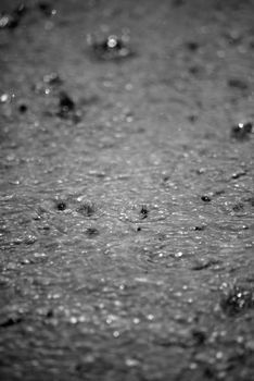 torrential rain splashing on the tarmac