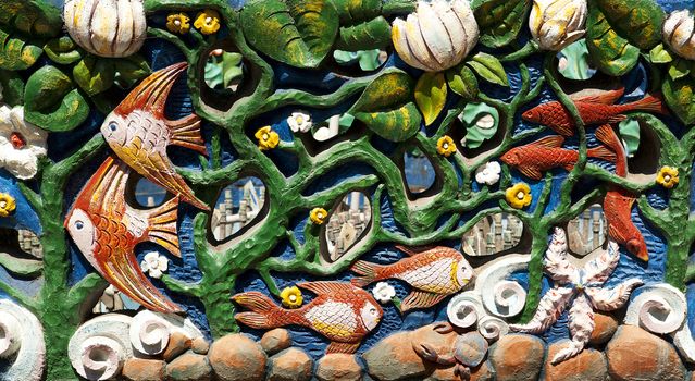 Sculpture of the underwater world with plants and fish.