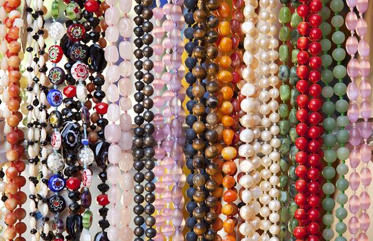 A large number of beads of different colors and shapes for sale.