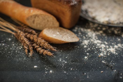 Bread composition with wheats. Very shallow DOF photo and specific art curly bokeh for extra volume.