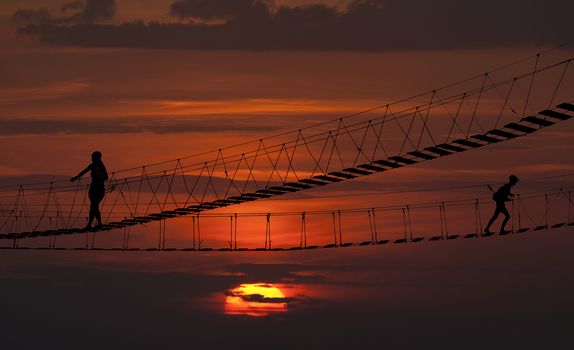 Suspension bridge over the ropes of the sunset.