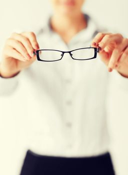 business and education concept - indoor picture of woman with eyeglasses