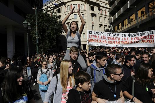 GREECE, Athens: Thousands of student-protesters fill the streets of Athens, Greece on November 2, 2015. The young demonstrators yell chants and carry signs as they rally against cuts to education and a shortage of teachers, amid ongoing protests against austerity in Greece. Reports from local media indicate that a contingent had broken off from the larger protest, vandalizing a cell phone store, and trying to damage a bank on Othonos, a street in Athens.