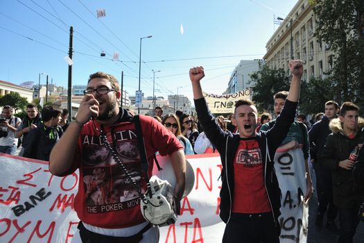 GREECE, Athens: A man talks on a bullhorn as thousands of student-protesters fill the streets of Athens, Greece on November 2, 2015. The young demonstrators yell chants and carry signs as they rally against cuts to education and a shortage of teachers, amid ongoing protests against austerity in Greece. Reports from local media indicate that a contingent had broken off from the larger protest, vandalizing a cell phone store, and trying to damage a bank on Othonos, a street in Athens.