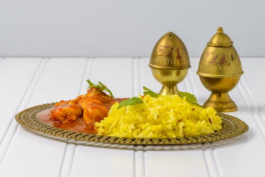 Plate of basmati rice and spicy chicken vindaloo.