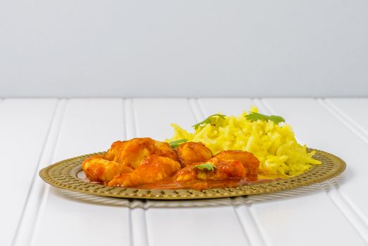 Plate of chicken vindaloo served with basmati rice.