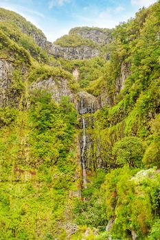 View of waterfall and greenish forest landscape on Madeira, the hiking and flower island