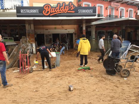PORTUGAL, Albufeira : Council workers are cleaning up the main square of Albufeira, southern Portugal, after the flash floods, on November 2, 2015. A man aged 79 died during the flooding. 