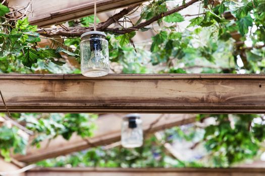 Terrace having a lightining system made by used glass jars as lamps