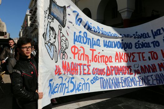 GREECE, Thessaloniki: A protester holds up a sign as hundreds of students rally in Thessaloniki, Greece's second-largest city, on November 2, 2015. They march to the Ministry of Macedonia and Thrace, protesting against the shortage of teaching staff in their schools and demanding more funding for education amid continued rallies against austerity.