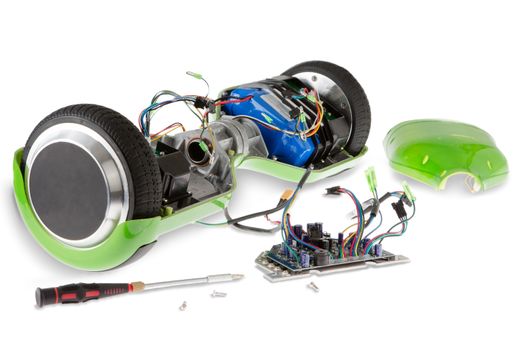 Close Up of Disassembled Dual Wheel Self Balancing Electric Skateboard on White Background with Screwdriver and Exposed Wires and Circuit Boards