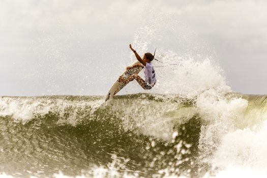 SNAPPER ROCKS, GOLD COAST, AUSTRALIA - 9 MARCH: Unidentified Surfer races the Quiksilver & Roxy Pro World Title Event. 9 March 2013, Snapper Rocks, Gold Coast, Australia