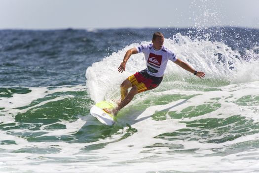 SNAPPER ROCKS, GOLD COAST, AUSTRALIA - 9 MARCH: Unidentified Surfer races the Quiksilver & Roxy Pro World Title Event. 9 March 2013, Snapper Rocks, Gold Coast, Australia