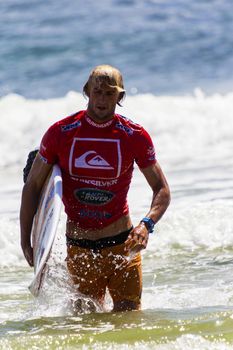 SNAPPER ROCKS, GOLD COAST, AUSTRALIA - 9 MARCH: Unidentified Surfer races the Quiksilver & Roxy Pro World Title Event. 9 March 2013, Snapper Rocks, Gold Coast, Australia