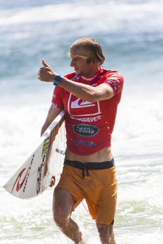 SNAPPER ROCKS, GOLD COAST, AUSTRALIA - 9 MARCH: Unidentified Surfer races the Quiksilver & Roxy Pro World Title Event. 9 March 2013, Snapper Rocks, Gold Coast, Australia