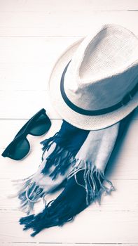 hat and blue with sunglasses scarf on white table vintage style