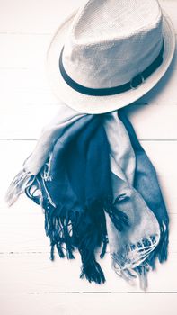 hat and blue scarf on white table vintage style