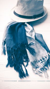 hat and blue scarf on white table vintage style