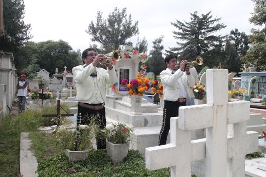 MEXICO, Mexico City: Two mariachis play the trumpet in front of a grave during the Day of the Dead ('Dia de los muertos' in spanish), in the cemetery of Iztapalapa, a huge district in eastern Mexico City, on November 2, 2015.