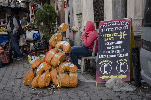 TURKEY, Izmir: A family of migrants beg on a street of Basmane, a poor district of Izmir, western Turkey, on October 25, 2015. There, Syrian refugees live in rotten buildings and cheap hotels, counting their days to leave Turkey for Greece or another European country. Everywhere on the streets of Basmane, passerby can spot banners and board signs written in Arabic, from money exchange, cafes, hotels, jewelry to life jackets for sale. It is estimated that there are currently over 74,000 registered Syrians in Izmir, but the number of unregistered refugees claims much higher, bringing the total well over 100,000 people. A survey conducted by the Association for Solidarity with Asylum Seekers and Migrants (ASAM) in Turkey showed that 45 percent among these are minors, the majority are without work or stable places to reside.