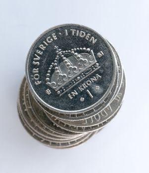Swedish One Coins Stacked with a white background close up macro image.