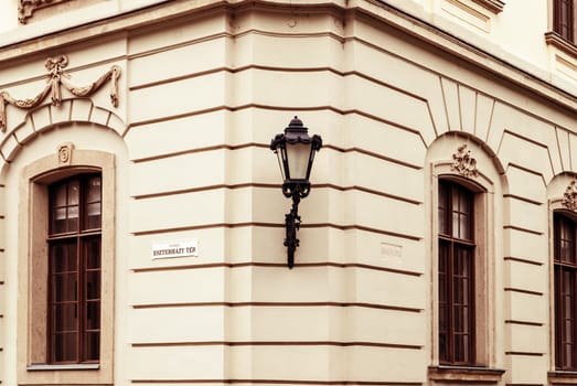 Ancient house and lamp on a wall in the city  Eger, Hungary