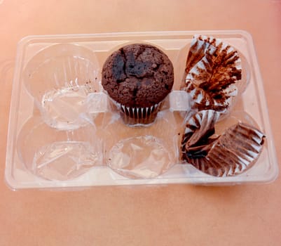 picture of a chocolate muffin on wood background