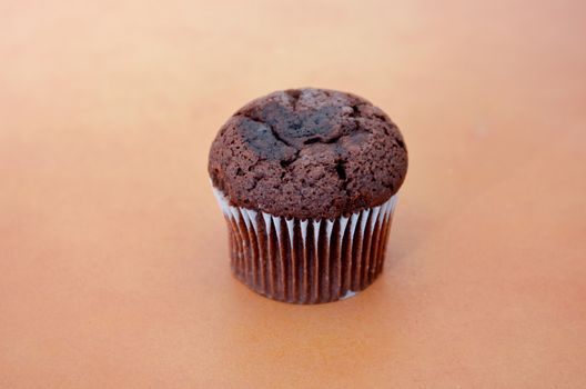 picture of a chocolate muffin on wood background