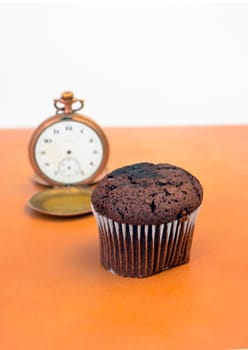 picture of a chocolate muffin on wood background