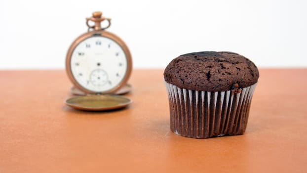 picture of a chocolate muffin on wood background