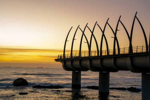 Sunrise over indian ocean and sillohette of Umhlanga Pier Durban SouthAfrica